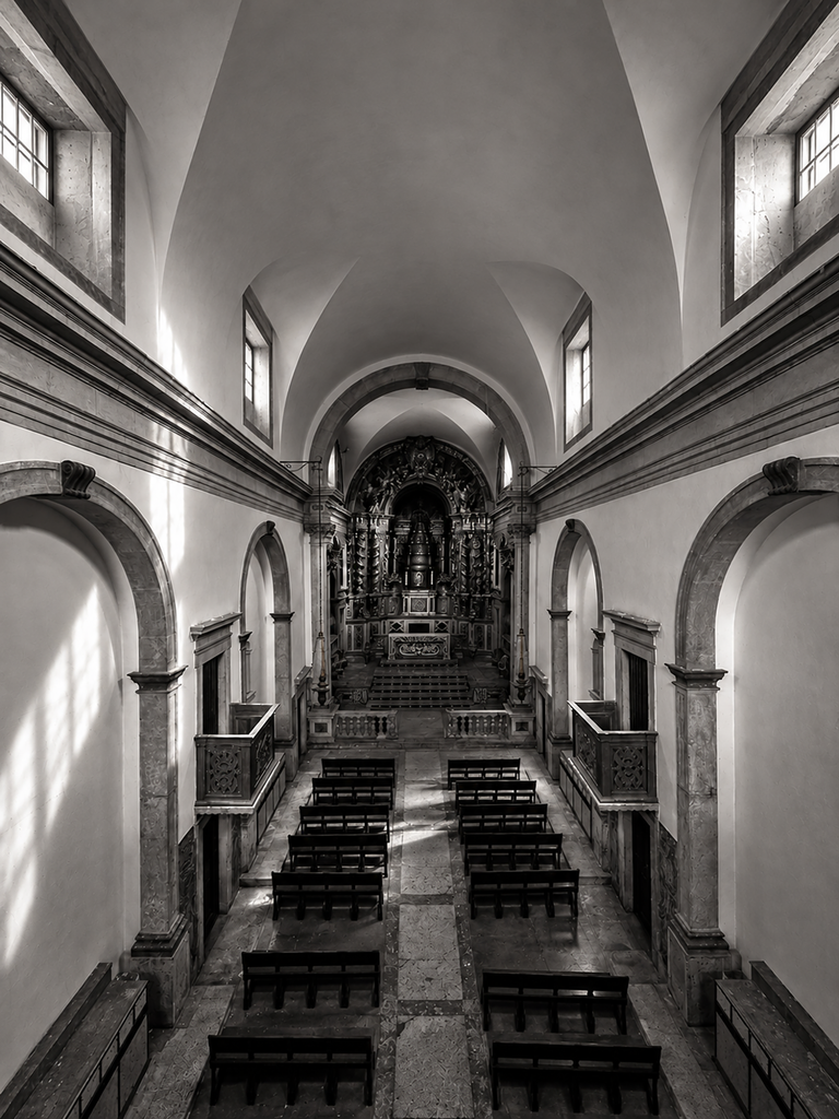 Historic chapel interior with vaulted ceiling and wooden pews at Nossa Senhora da Estrela Convent